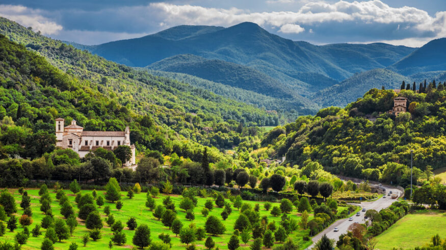 View of the green and beautiful Umbria countryside with the St Peter Extra Moenia ancient church from the city of Spoleto