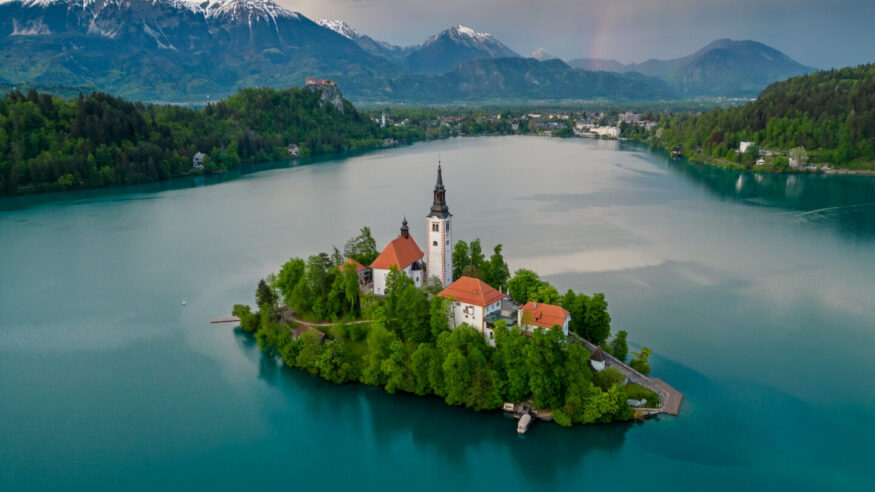 Aerial view of Bled lake landscape with the Pilgrimage Church of the Assumption of Maria on a small island after sunset, Slovenia