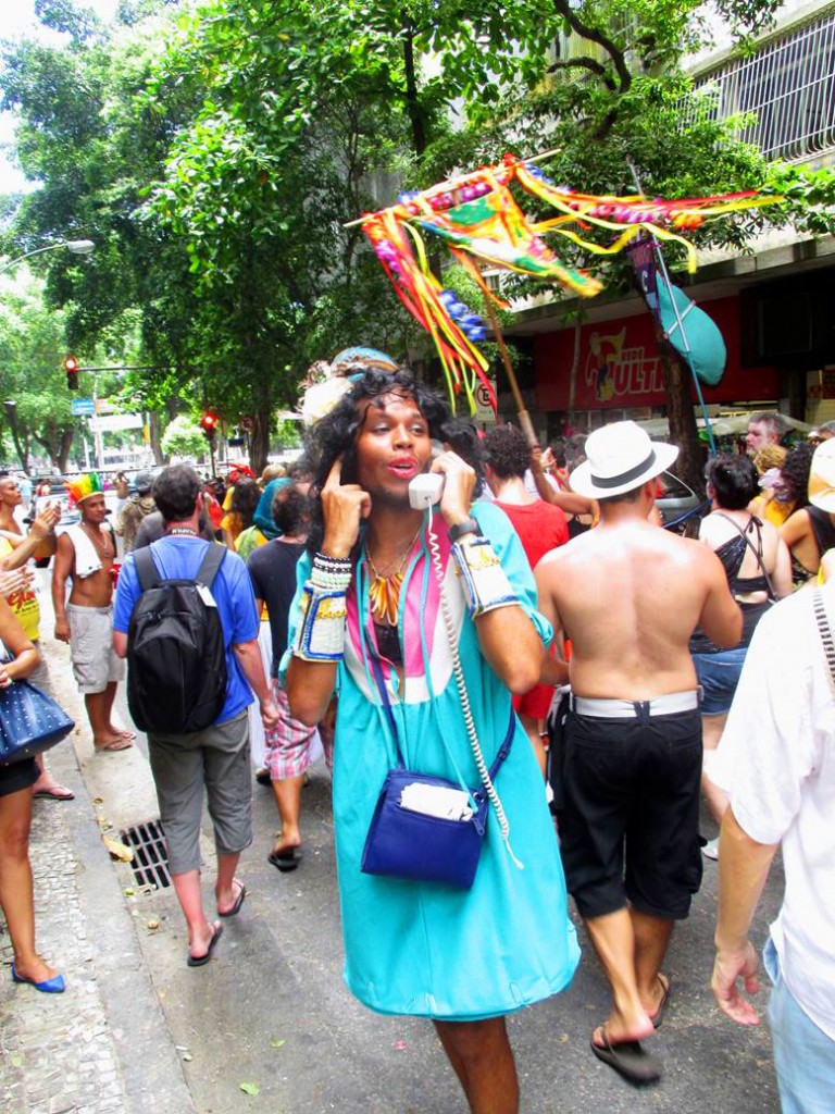 A festive fellow “talking on the phone” during a bloco